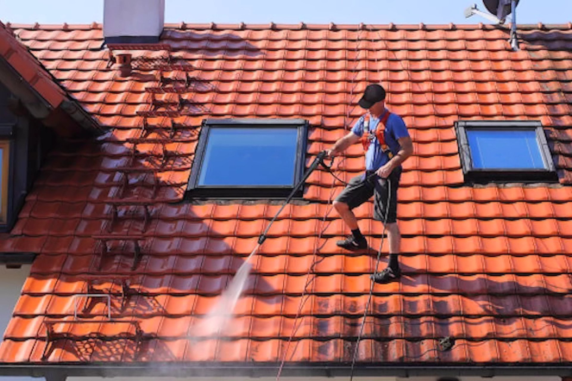 Professional roof cleaning in action